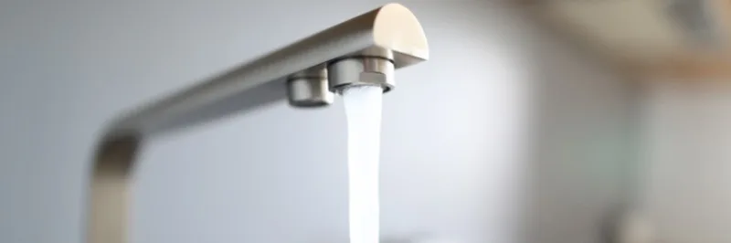 Modern kitchen faucet running water, installed by Spencer Hallett Plumbing