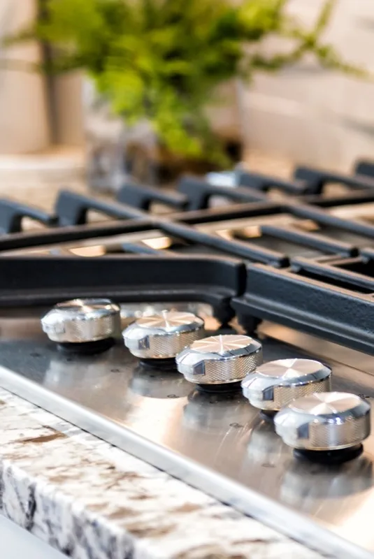 Gas stove burners on a kitchen countertop